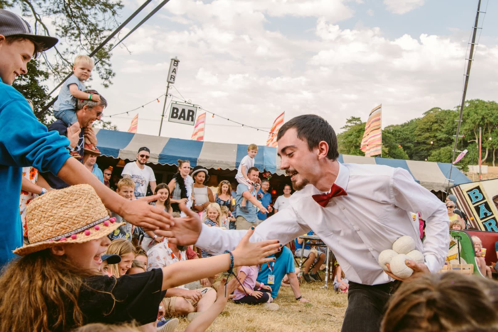 Cal high-fiving children at Camp Bestival. A festival on the Isle of Wight.